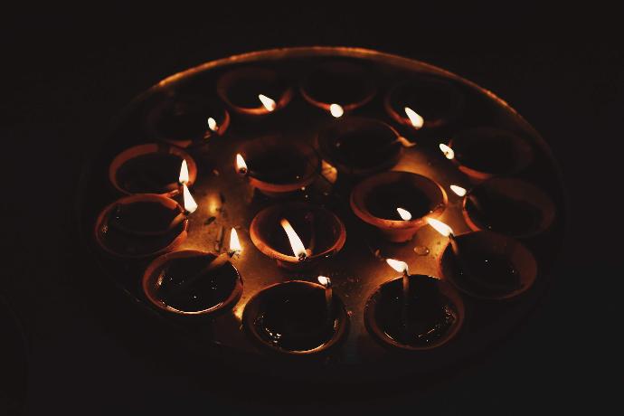 a group of lit candles sitting on top of a table
